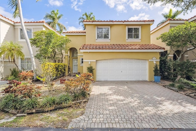 mediterranean / spanish home featuring a garage