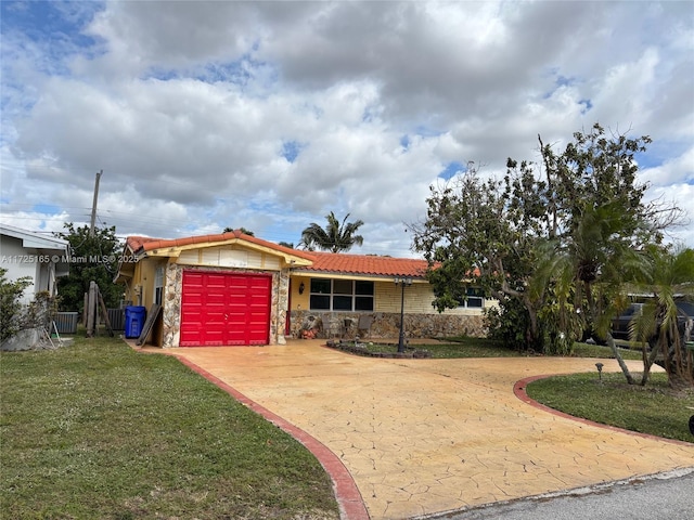 ranch-style home featuring a garage and a front yard