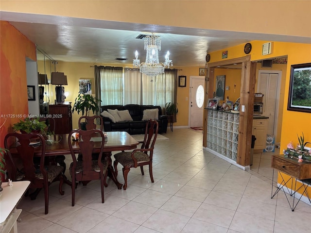 tiled dining area with plenty of natural light and an inviting chandelier