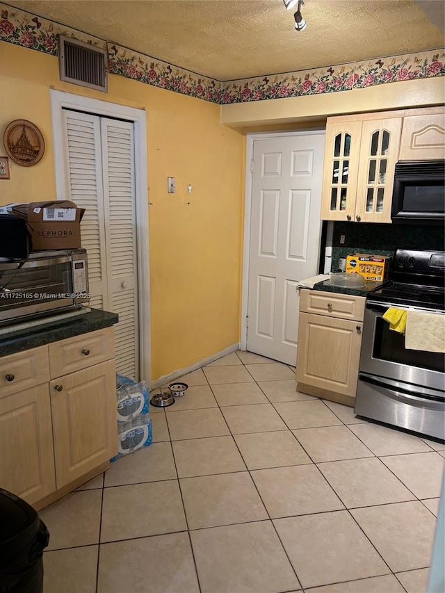 kitchen with stainless steel electric range, decorative backsplash, a textured ceiling, light tile patterned floors, and rail lighting