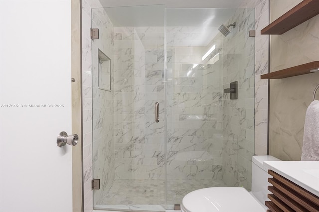 bathroom featuring toilet, an enclosed shower, and vanity