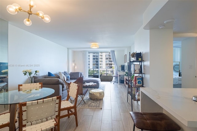 living room featuring expansive windows, a chandelier, and hardwood / wood-style flooring