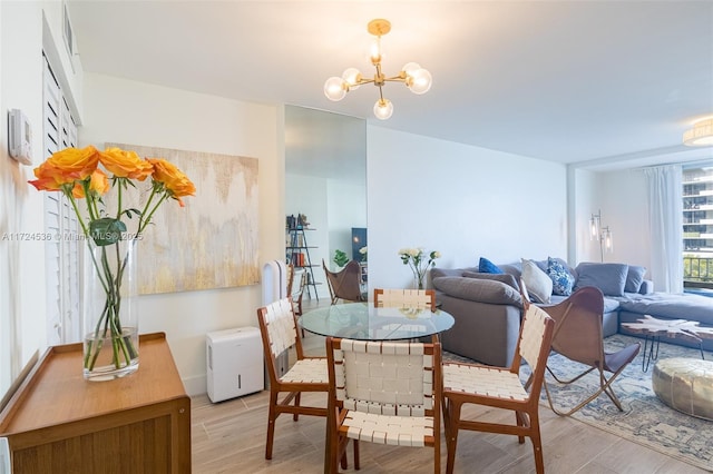 dining room featuring an inviting chandelier and light hardwood / wood-style flooring