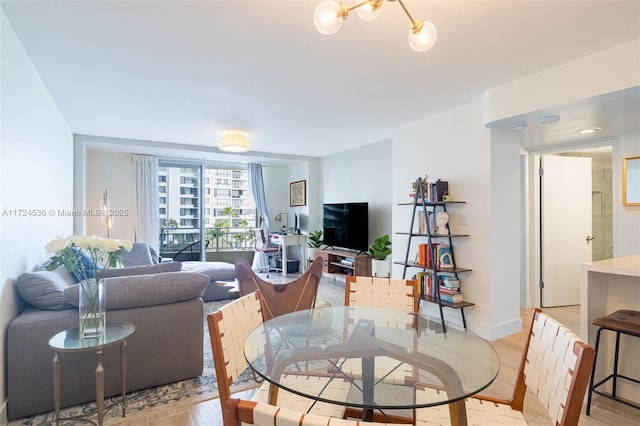 living room with a chandelier and light hardwood / wood-style floors