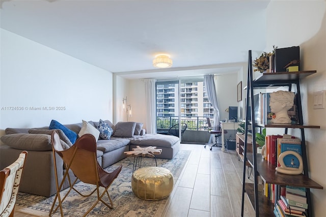 living room with hardwood / wood-style flooring and a wall of windows