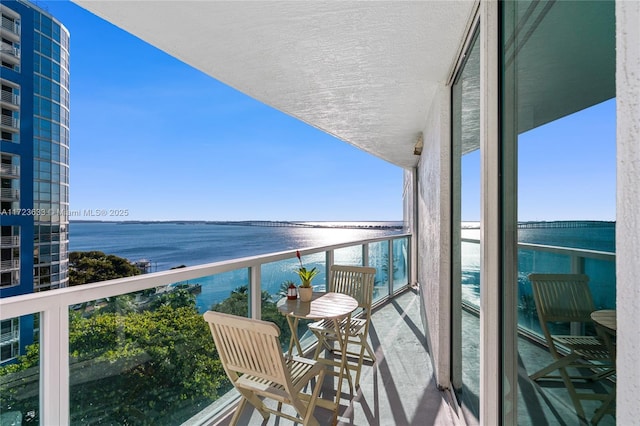 balcony featuring a water view