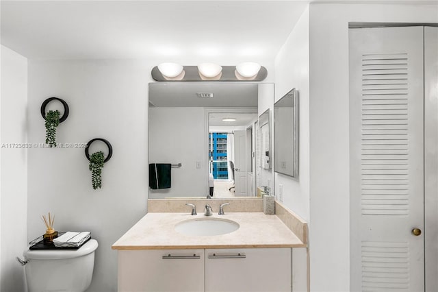 bathroom featuring toilet and vanity