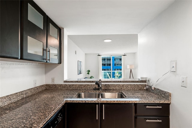 kitchen featuring dark stone countertops and sink