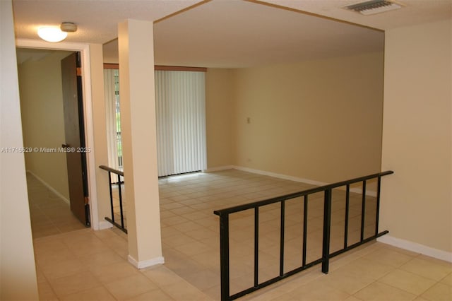 stairs with a textured ceiling and tile patterned floors