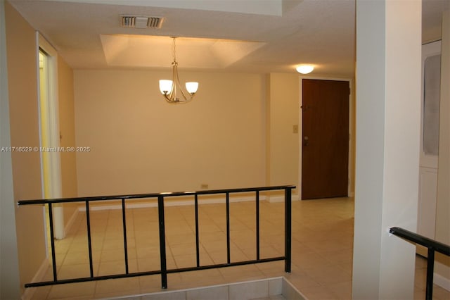 staircase featuring tile patterned flooring and an inviting chandelier