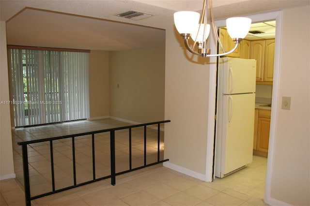 stairs featuring tile patterned floors and a notable chandelier