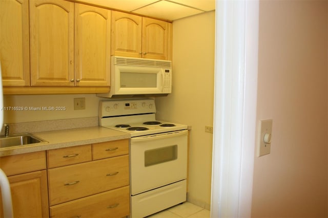 kitchen featuring sink, white appliances, light brown cabinetry, and light tile patterned floors