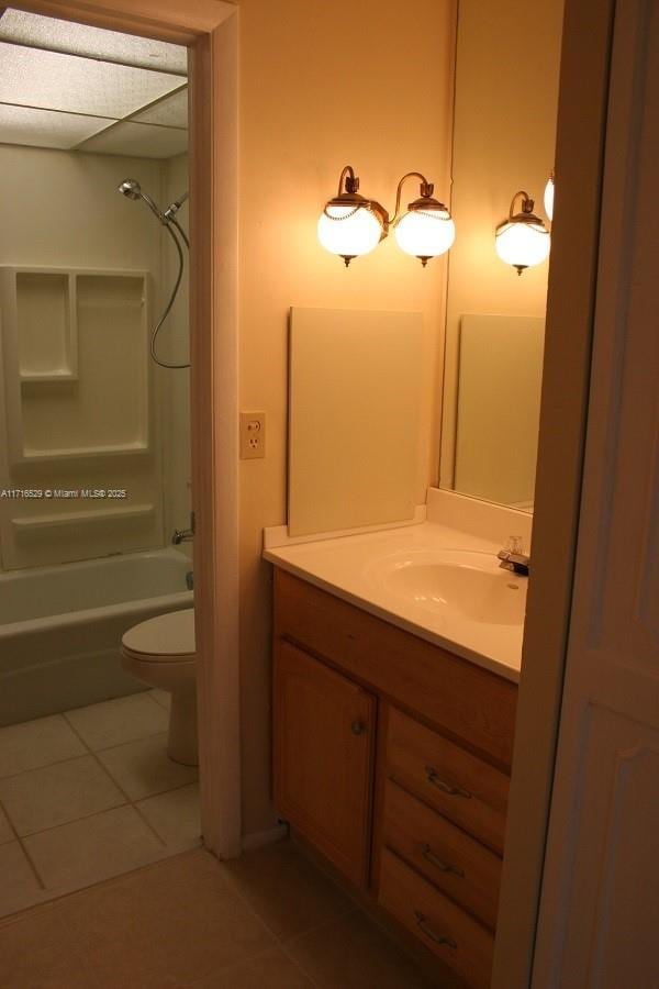 full bathroom with shower / bath combination, vanity, tile patterned floors, and toilet