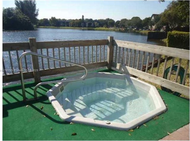 view of swimming pool featuring a water view