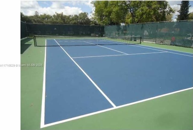 view of tennis court featuring basketball hoop