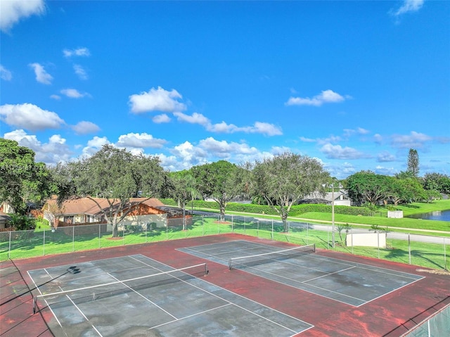 view of sport court with a water view