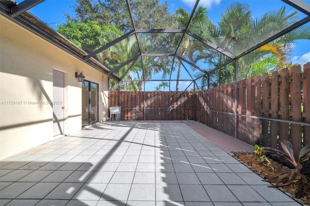 view of patio featuring a lanai