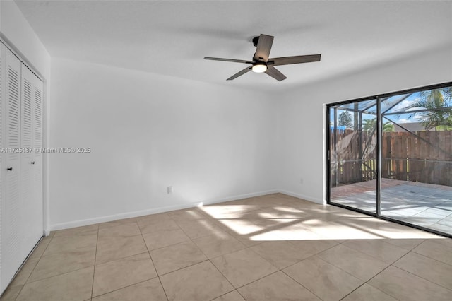 spare room with ceiling fan and light tile patterned floors