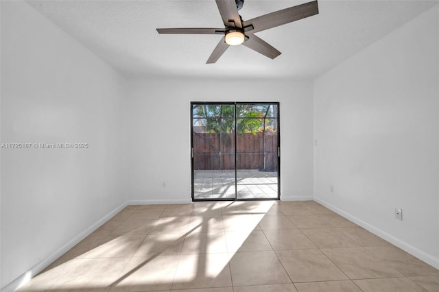 tiled empty room with ceiling fan