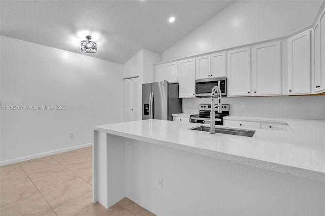 kitchen with stainless steel appliances, white cabinetry, light tile patterned floors, and kitchen peninsula