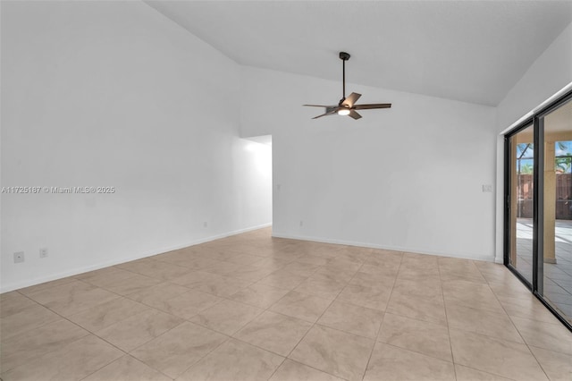 empty room featuring ceiling fan, vaulted ceiling, and light tile patterned floors