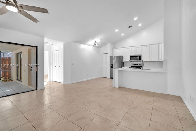 kitchen with stainless steel appliances, white cabinets, ceiling fan, light tile patterned floors, and kitchen peninsula