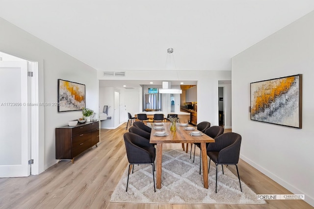 dining area with light wood-type flooring