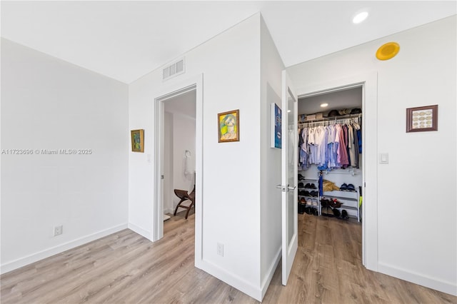 corridor with light wood-type flooring