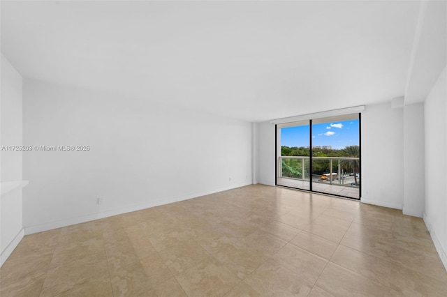 unfurnished room featuring a wall of windows and light tile patterned flooring