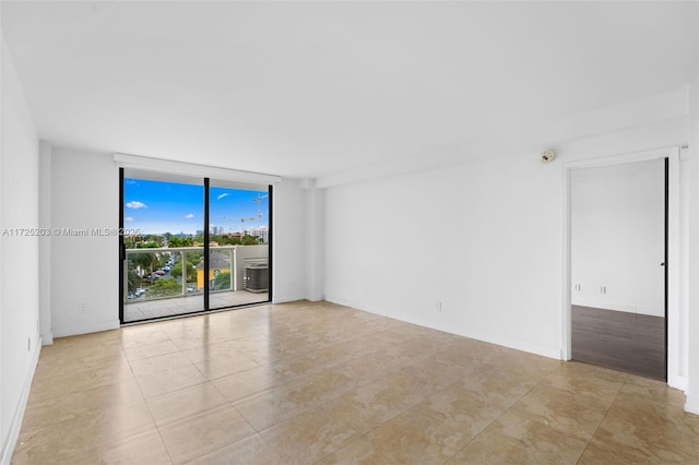 tiled empty room with a wall of windows