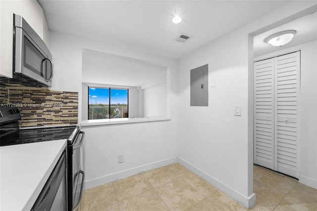 kitchen with electric panel, light tile patterned floors, black range with electric stovetop, and tasteful backsplash