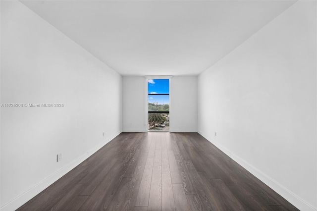 unfurnished room featuring dark hardwood / wood-style flooring