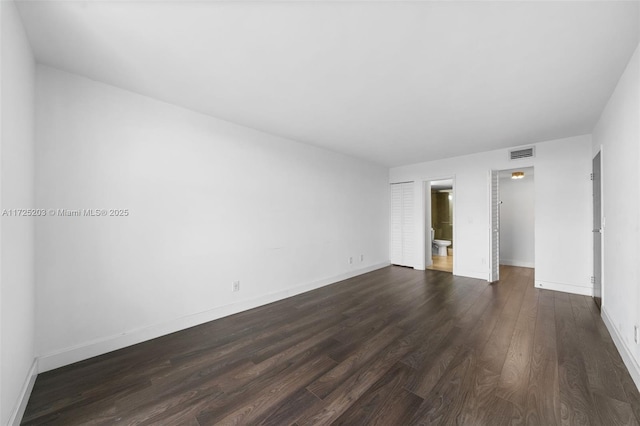 spare room featuring dark hardwood / wood-style floors