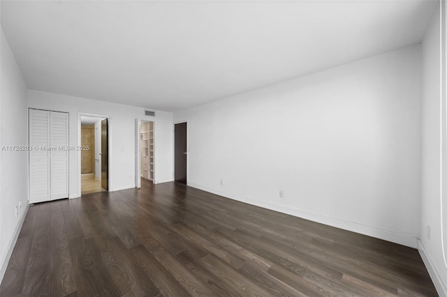 unfurnished bedroom featuring dark hardwood / wood-style flooring