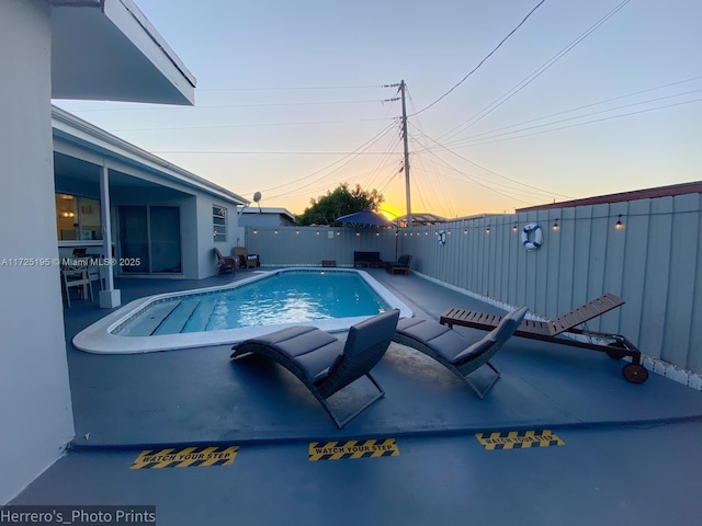 view of pool at dusk