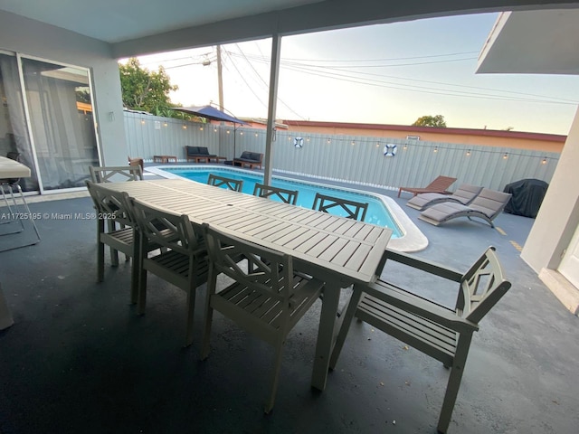 pool at dusk with a patio