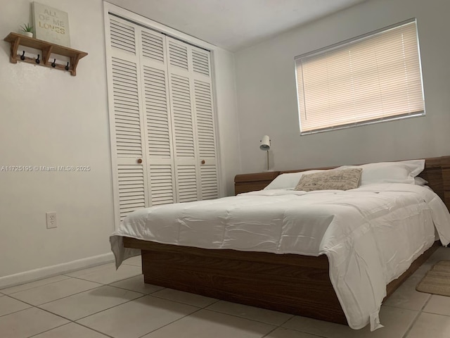 bedroom with light tile patterned flooring and a closet