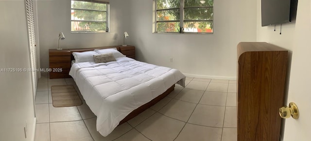 bedroom with light tile patterned floors