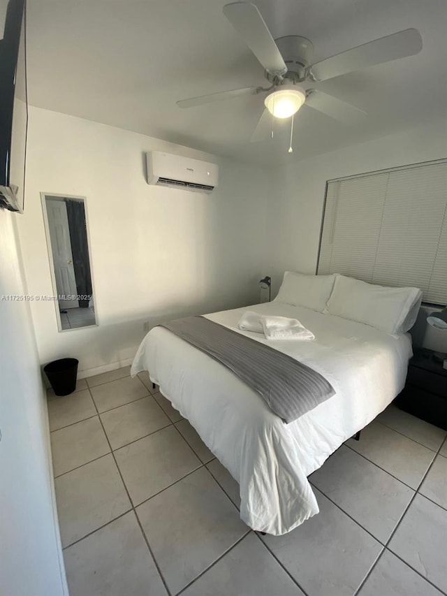 tiled bedroom featuring an AC wall unit and ceiling fan