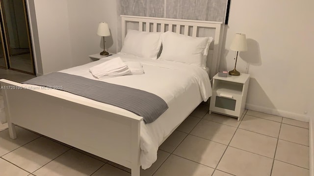 bedroom with light tile patterned floors