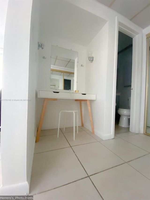 bathroom featuring toilet and tile patterned flooring