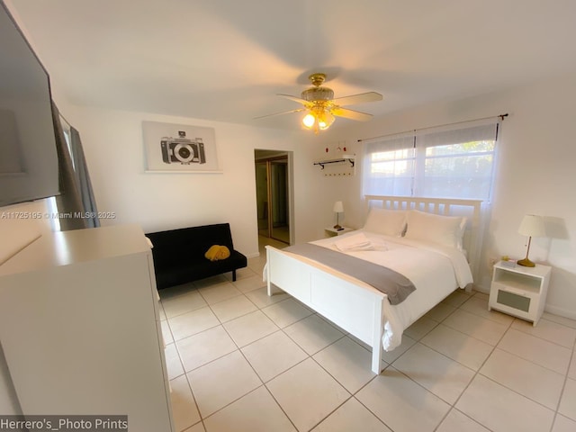 tiled bedroom featuring ceiling fan