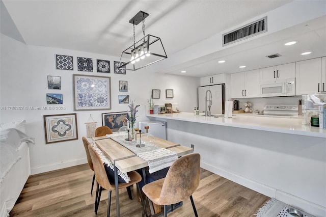 dining room with hardwood / wood-style flooring