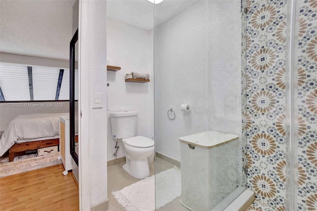 bathroom featuring toilet, walk in shower, and hardwood / wood-style floors