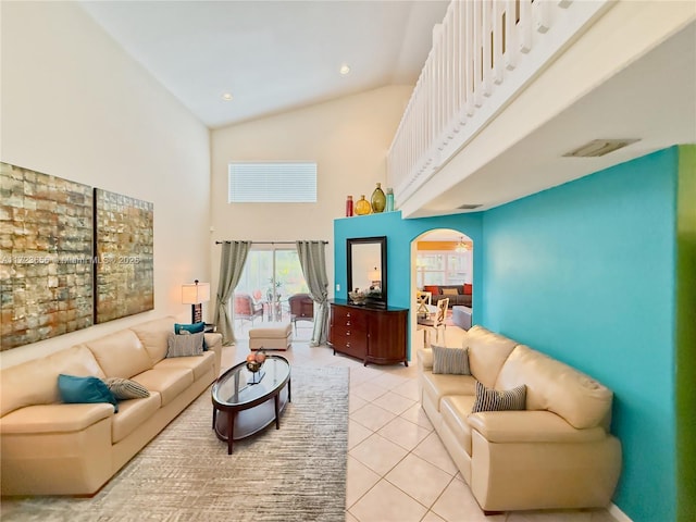 living room with high vaulted ceiling and light tile patterned floors