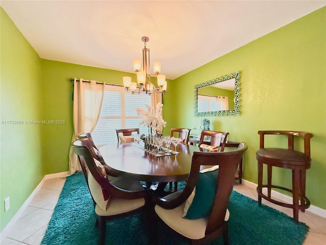 dining area with a chandelier and light tile patterned floors