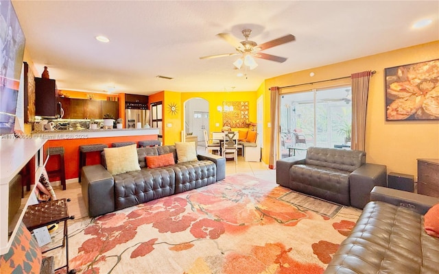 tiled living room with ceiling fan