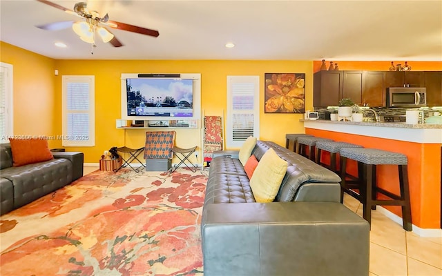 tiled living room with ceiling fan