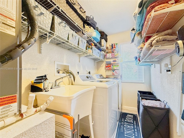 laundry room featuring sink and washing machine and clothes dryer