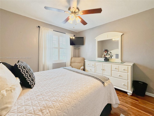 bedroom featuring ceiling fan and hardwood / wood-style flooring